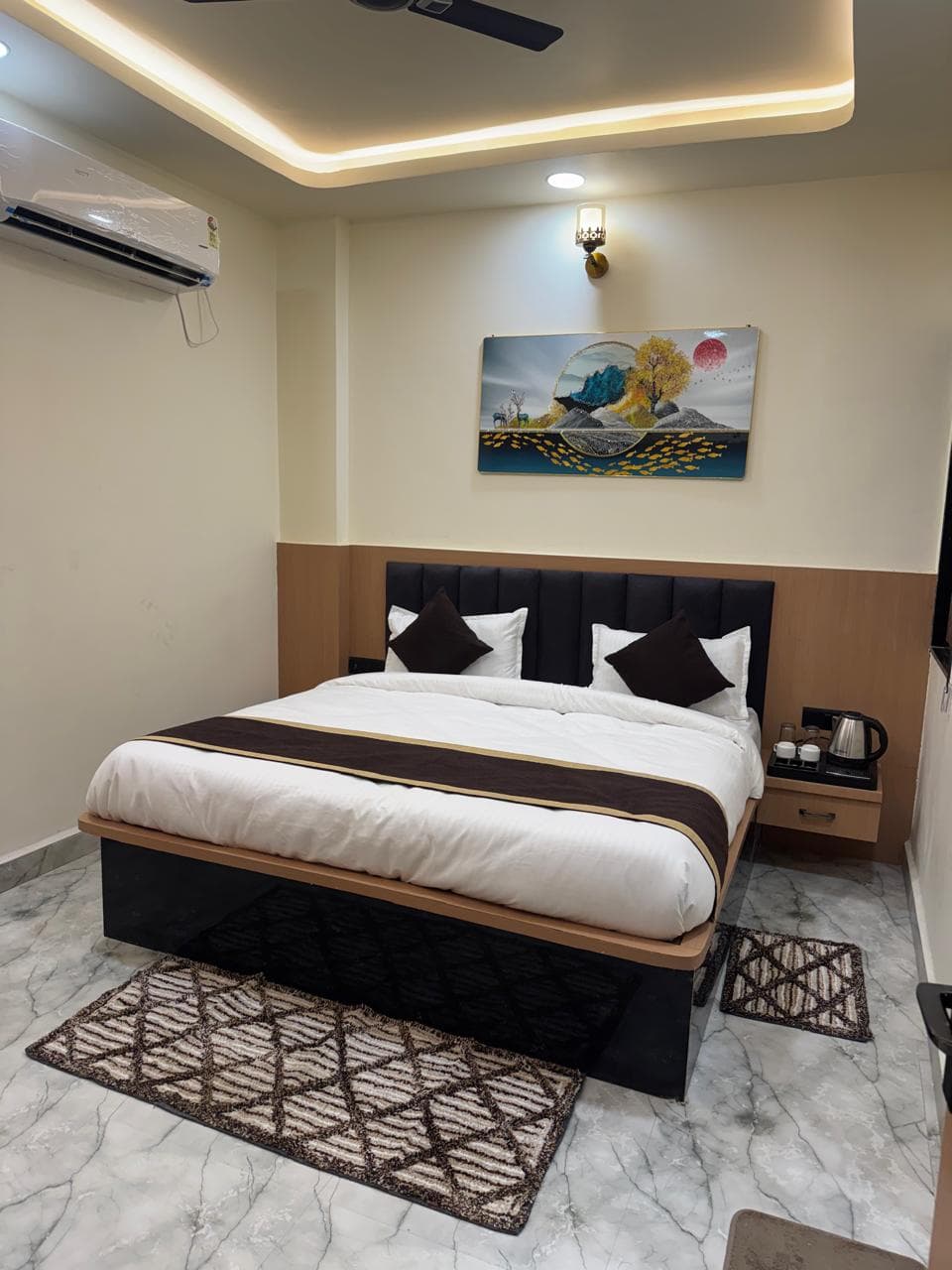 A clean hotel room with a double bed and air conditioning